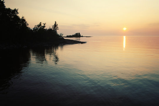Ladoga lake at sunset. Aged photo in retro style.
