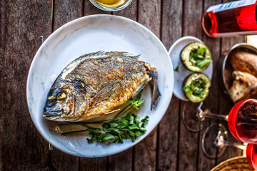 Grilled fish on white plate.