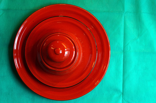 Red Sugar Bowl Is On A Saucer And On A Plate