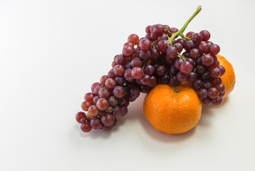 Oranges and grapes on white background
