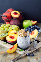Healthy breakfast or morning snack with chia seeds pudding, fruits and granola muesli