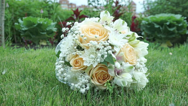 Wedding Bouquet On The Grass in cloudy weather, slider shot