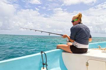 Woman deep sea fishing
