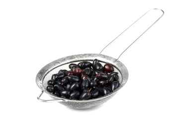currants in a bowl on a white background