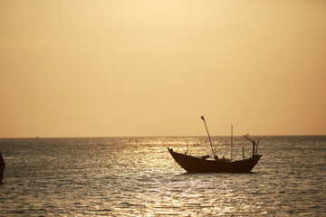fishing boats in the sea at sunset