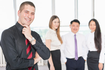 Successful young business man and his business team
