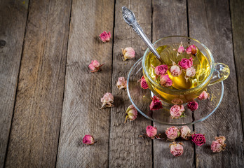 Cup of green tea with dried roses