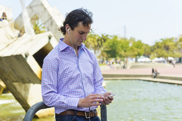 Young man using a mobile device for entertainment and information
