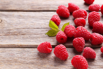 Red raspberries on grey wooden background