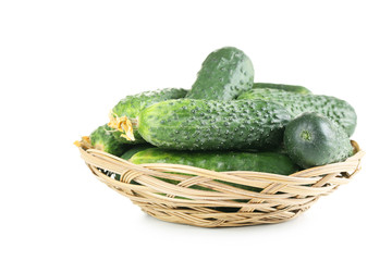 Fresh cucumbers in basket isolated on white