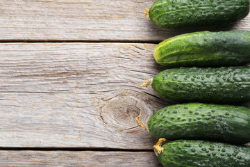 Fresh cucumbers on grey wooden background
