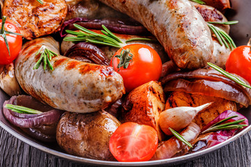 Grilled sausages and vegetables  in  rustic style.