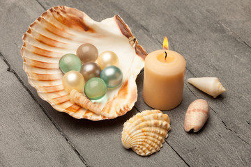 Bath pearls in a shell over wooden table