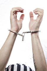 hands with handcuffs. Prison riot concept.