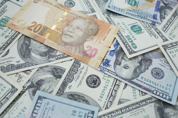 Fototapeta na wymiar twenty rand against the background of dollars