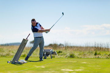Golf player on the golf field. Cape Kidnappers golf court. New Zealand.