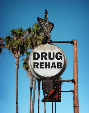 aged and worn vintage photo of drug rehab sign with palm trees