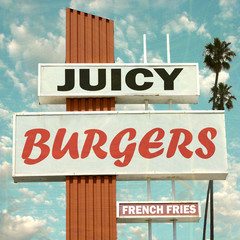 aged and worn vintage photo of juicy burgers sign