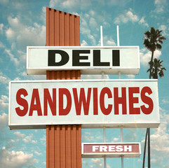 aged and worn vintage photo of deli sandwiches sign