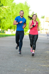 Fototapeta premium Runners training outdoors working out. City running couple