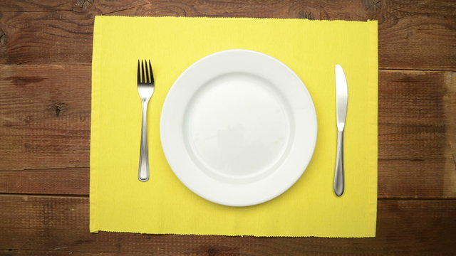 Table setting on wooden rustic dinning table for one person - stop motion animation