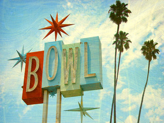 aged and worn vintage photo of bowling sing with palm trees