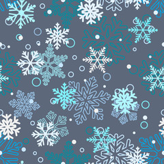 Seamless pattern of snowflakes, white and blue on gray