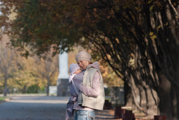 Fototapeta premium Mom hugging baby outdoors