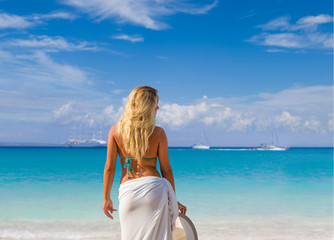 woman in white sarong on the beach.
