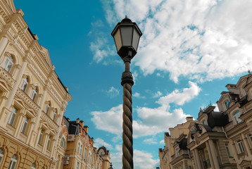 Fototapeta na wymiar Vintage street lantern against blue cloudy sky