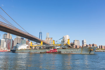 Bulk carrier navigating on East river in New York.