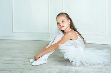 A little adorable young ballerina in a playful mood in the inter © jutaphoto