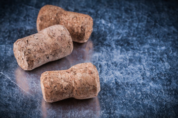 Champagne cork stoppers on metallic background food and drink co