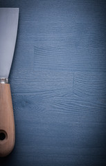 copyspace image paint scraper on blue wood board