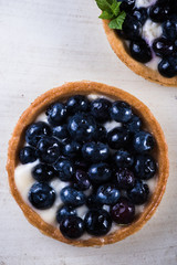 Homemade blueberry tart on white wood