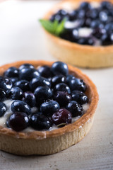 Homemade blueberry tart on white wood