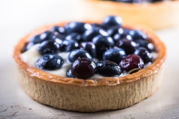 Homemade blueberry tart on white wood