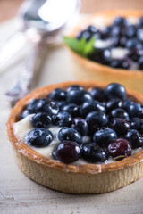 Homemade blueberry tart on white wood