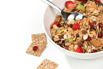 Muesli cereals bowl and spoon with almond, pine nuts, walnut, ra