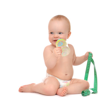 Infant child baby tape measure measuring body drinking from feed