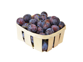 Plum in a wattled basket, isolated on a white background