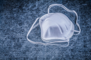 Safety dust mask on metallic background construction concept