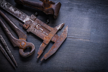 close up view vintage rusted tools on old board