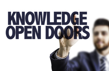 Business man pointing the text: Knowledge Open Doors