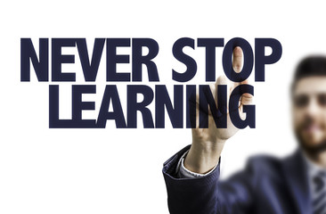 Business man pointing the text: Never Stop Learning