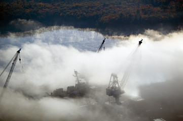 Aerial view of fog over Bath Iron Works and Kennebec River in Maine.  Bath Iron Works is a leader...