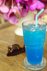 Ice blue soda on timber table