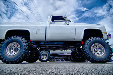 huge truck with huge wheels at a classic car show in a small tow © digidreamgrafix