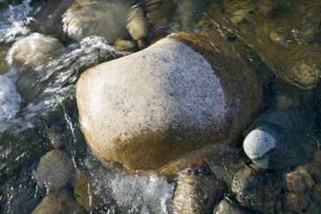 Rock in autumn stream at Crawford Notch State Park in White Mountains of New Hampshire, New England