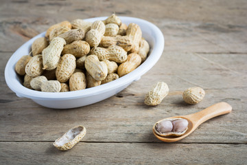 Boiled peanuts on wooden background.